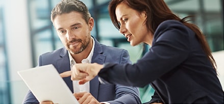 Two people discussing a document