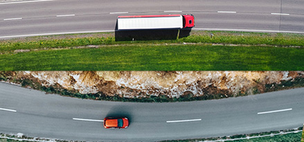 A birds view of a road with cars and a truck