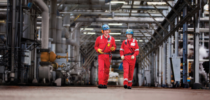 Three ExxonMobil workers smiling at workplace