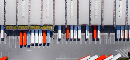 A birds view of a row of red and white trucks 